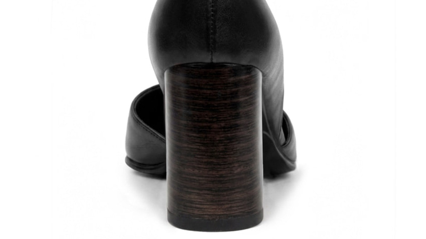 Close-up of the stacked-leather heel construction of a black Sainte Alba heel