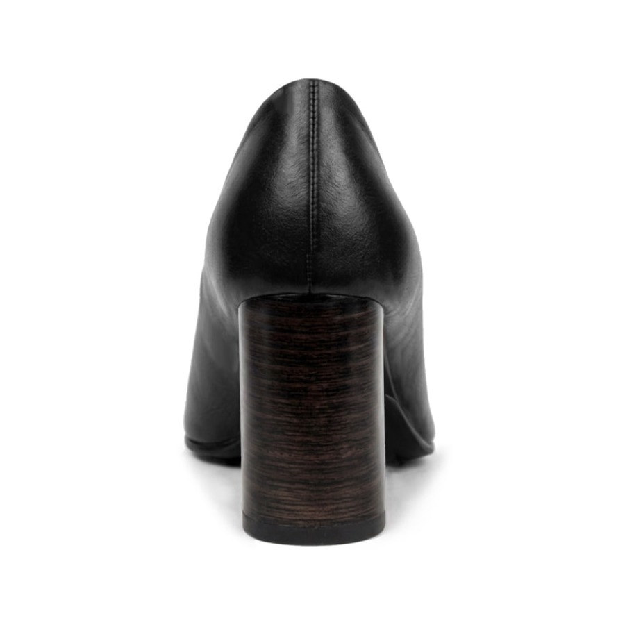 Close-up of a cognac pump's stacked leather heel and replaceable heel tip
